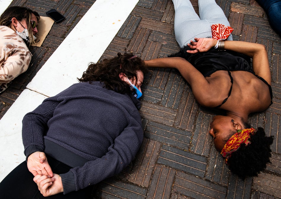 Erica Joos, left, and Jenelle Figgins comfort each other as they lay on the ground for nine minutes to honour George Floyd during a peaceful protest in Aspen, Col. on May 31, 2020.