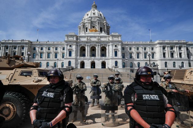 National Guardsmen and Minnesota state police form a barricade as protesters gather outside the Minnesota State Capitol on Sunday in Minneapolis.