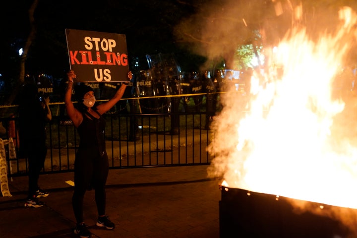 A fire burns in a dumpster near the White House in Washington. 