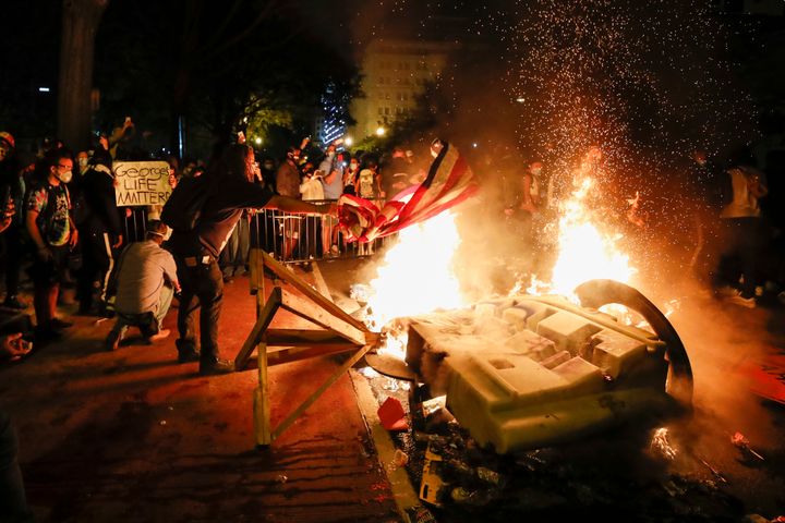 Demonstrators start a fire as they protest the death of George Floyd near the White House in Washington, D.C. on Sunday night.