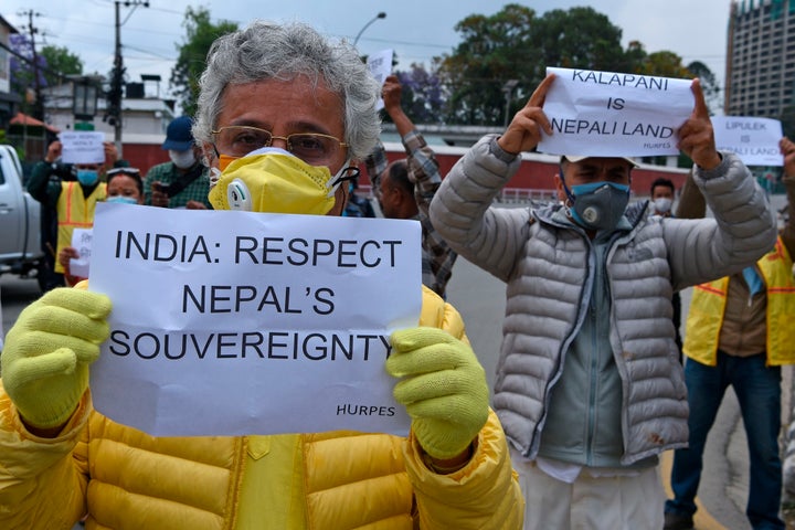 Activists hold placards during a protest against India's newly inaugurated road, near the Indian embassy in Kathmandu on May 12, 2020.