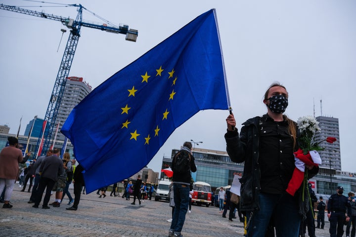 A man holding an European Union flag participates in a protest in Warsaw, Poland, on May 23, demanding more financial su