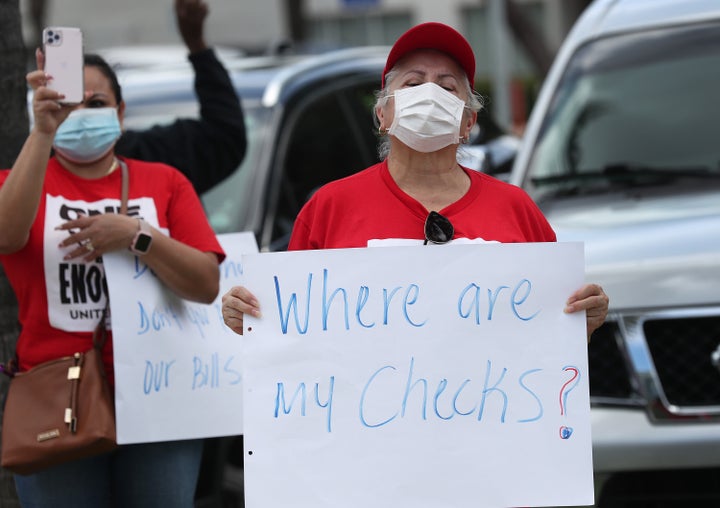 Protesters stand together demanding that the state of Florida fix its unemployment system on May 22 in Miami Beach, Florida.