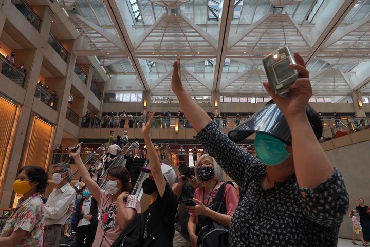 Protesters gesture with five fingers, signifying the "Five demands - not one less" in a shopping mall during a protest against China's national security legislation for the city, in Hong Kong, on June 1, 2020. 