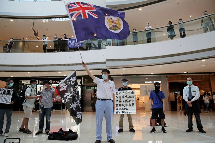 Protesters wave a Hong Kong colonial flag in a shopping mall during a protest against China's national security legislation for the city, in Hong Kong, on May 29, 2020. 