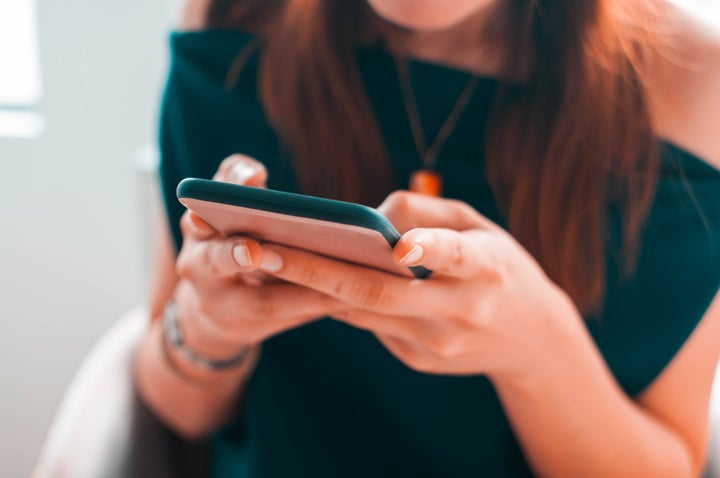 A close-up view of a young woman using her smartphone