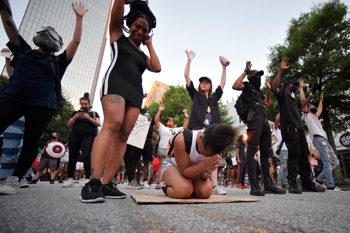 Demonstrators pray during a march, Sunday, May 31, 2020, in Atlanta. (AP Photo/Mike Stewart)