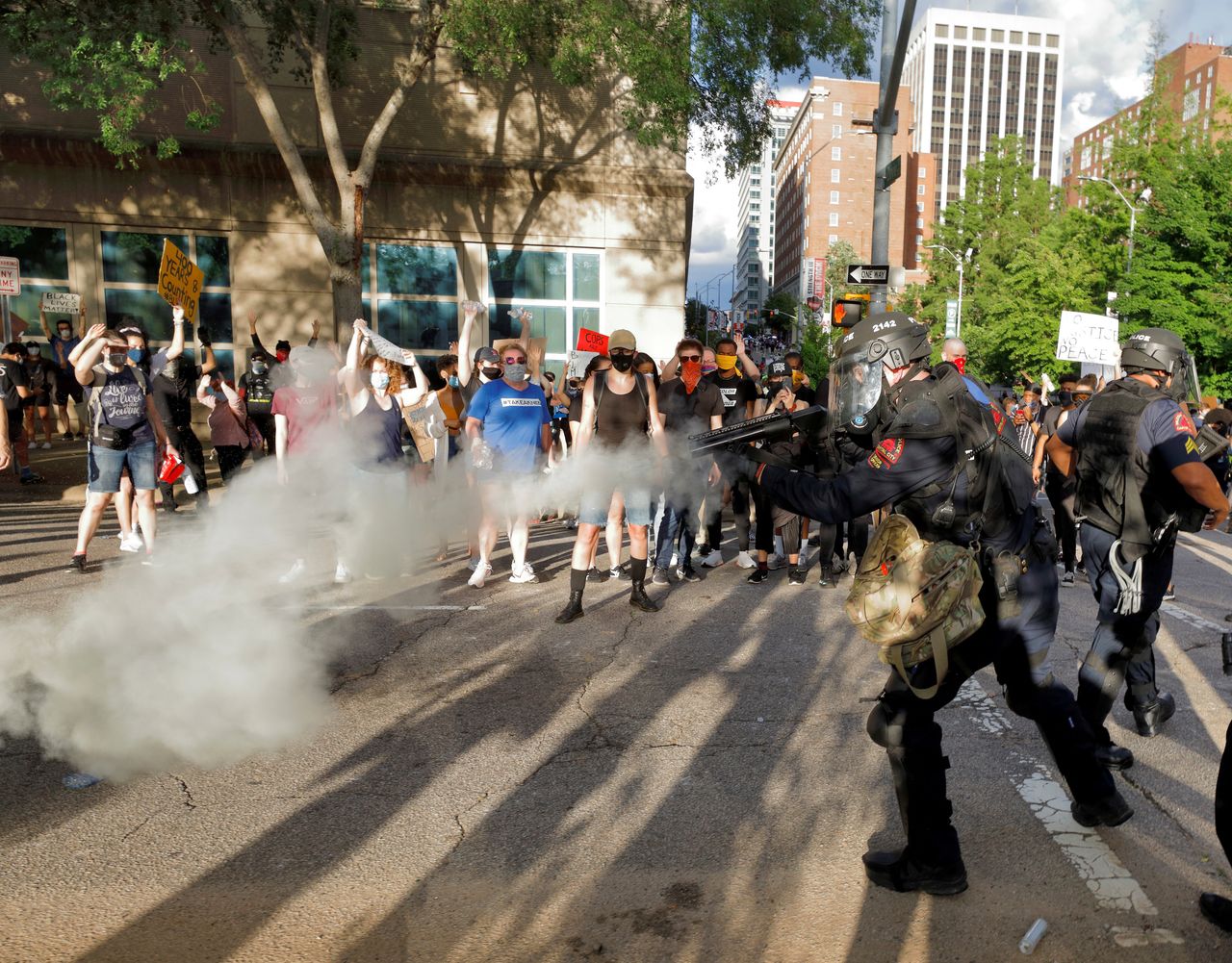 A policeman fires a tear gas canister at protesters in Raleigh, North Carolina.