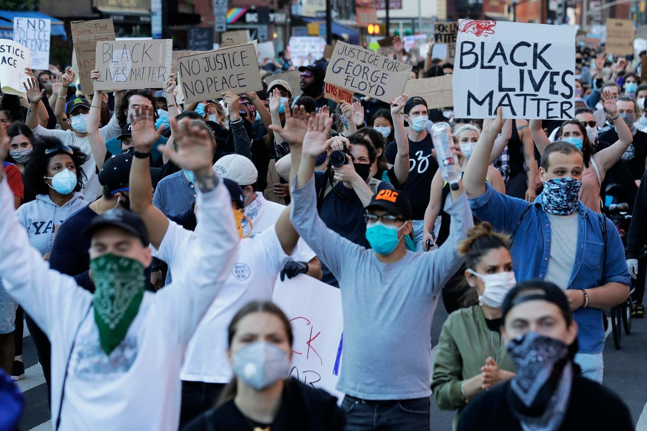Demonstrators march in the streets of Manhattan on Sunday.