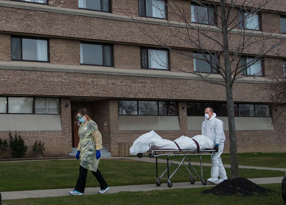 A body is wheeled from the Eatonville Care Centre in Toronto on April 14, 2020. The brutal assault of...