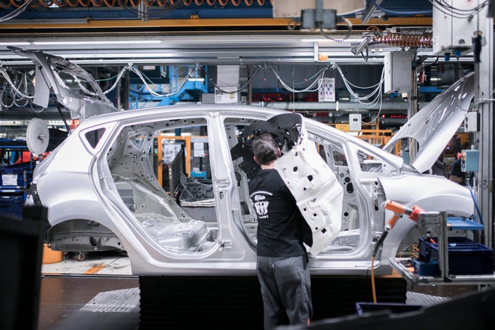 Un mecánico ensambla piezas de un Ford Fiesta.