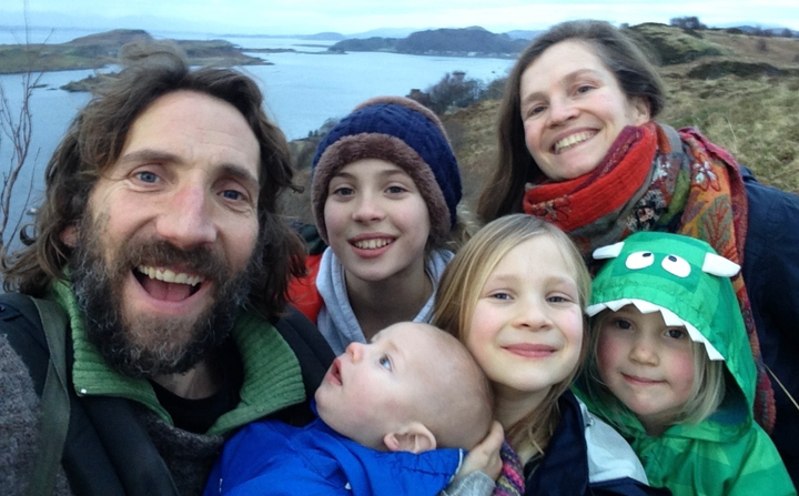 Daniel Brooks on a beach with his wife Deborah and their four children