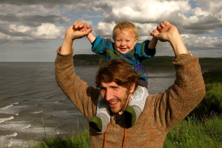 Fun on the beach: Daniel Brooks with his one-year-old son Oak