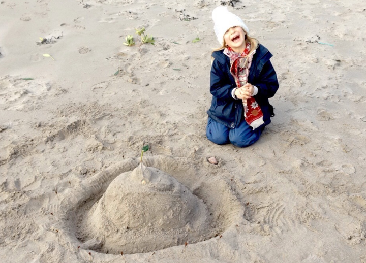 Daniel Brooks daughter building sandcastles on a beach