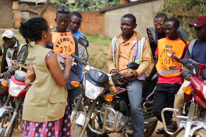 Martine Milonde, left, a Congolese community mobilizer who works with the aid group World Vision in Beni, eastern Congo, which became the epicenter of the Ebola outbreak, engages the public about coronavirus prevention on April 10.