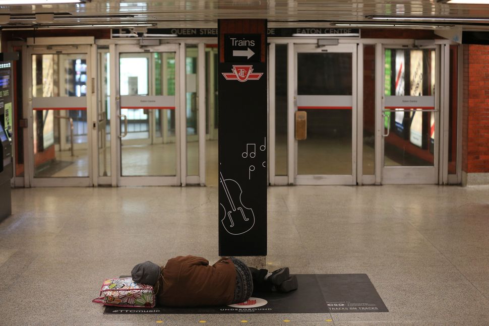 A person sleeps at a Toronto subway station on April 13,