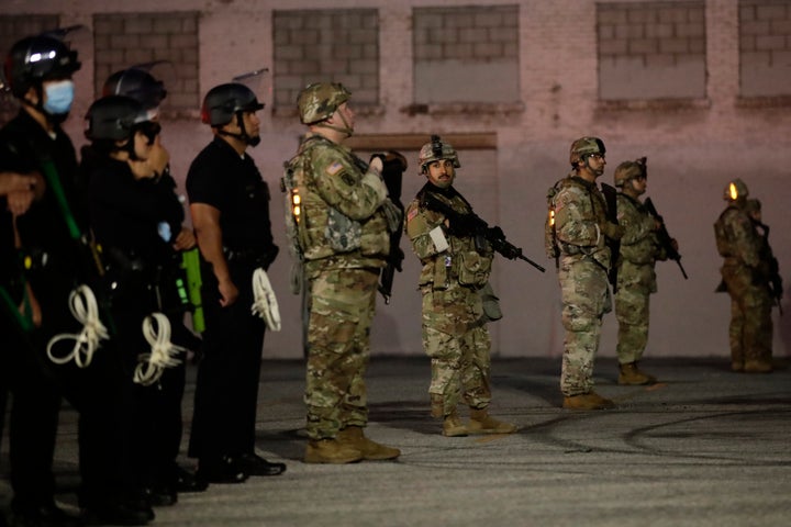 Heavily armed National Guardsmen join Los Angeles police officers during protests Sunday over the death of George Floyd at th