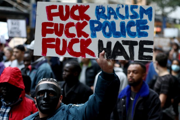 AUCKLAND, NEW ZEALAND - JUNE 01: (EDITOR'S NOTE: Image contains profanity.) Protestors march down Queen...