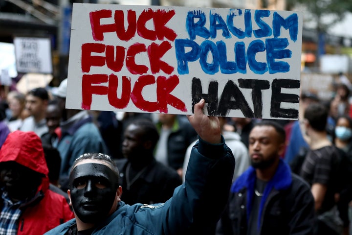 AUCKLAND, NEW ZEALAND - JUNE 01: (EDITOR'S NOTE: Image contains profanity.) Protestors march down Queen Street on June 01, 2020 in Auckland, New Zealand. The rally was organised in solidarity with protests across the United States following the killing of an unarmed black man George Floyd at the hands of a police officer in Minneapolis, Minnesota. (Photo by Hannah Peters/Getty Images)