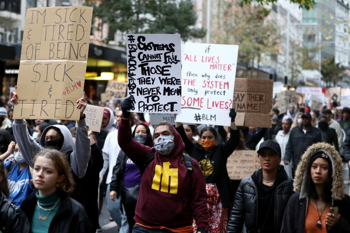 AUCKLAND, NEW ZEALAND - JUNE 01: Protestors march down Queen Street on June 01, 2020 in Auckland, New Zealand. The rally was organised in solidarity with protests across the United States following the killing of an unarmed black man George Floyd at the hands of a police officer in Minneapolis, Minnesota. (Photo by Hannah Peters/Getty Images)