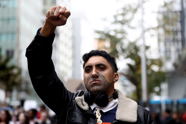 AUCKLAND, NEW ZEALAND - JUNE 01: A protestor marches down Queen Street on June 01, 2020 in Auckland, New Zealand. The rally was organised in solidarity with protests across the United States following the killing of an unarmed black man George Floyd at the hands of a police officer in Minneapolis, Minnesota. (Photo by Hannah Peters/Getty Images)