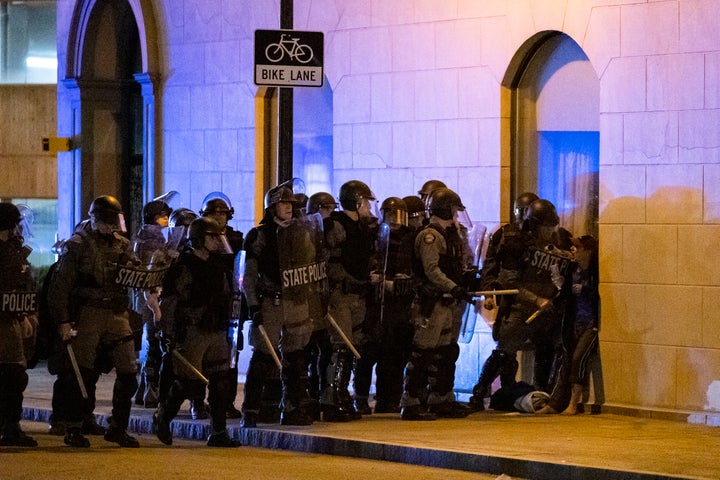 Police confront a woman (on the right) as they sought to clear a block during protests on Saturday in Louisville, Kentucky. Even before the May 25 police killing of a Black man in Minneapolis sparked nationwide protests, tensions already were high in Louisville due to the deadly police shooting in March of a Black woman.