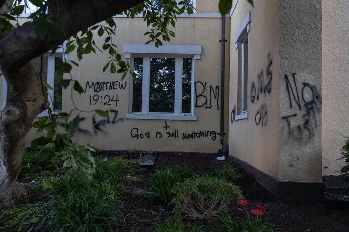 Graffiti says "God is still watching" on the exterior walls of St. John's Episcopal Church near the White House on June 1, 2020, after a night of protests over the death of George Floyd.