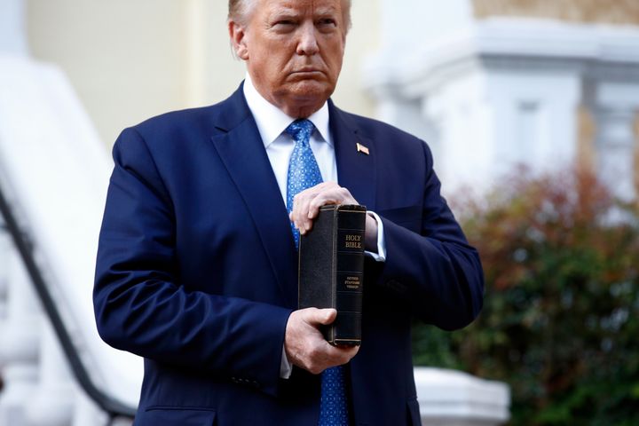 Donald Trump holds a Bible as he visits outside St John's Church across Lafayette Park from the White House.