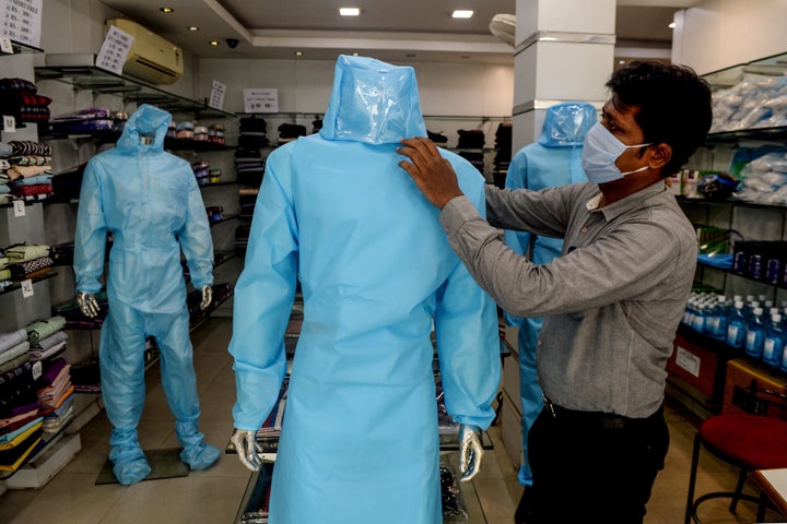 A shopkeeper arranges a protective suit for sale on a mannequin at a garment shop after the government eased a nationwide lockdown, in Chennai on May 28, 2020.