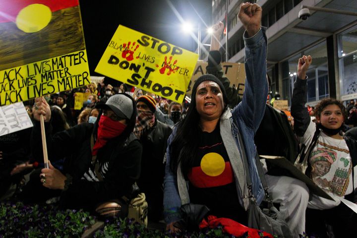Protestors chant and bend down on their knees in Martin Place during a 'Black Lives Matter' rally on June 02, 2020 in Sydney, Australia. 