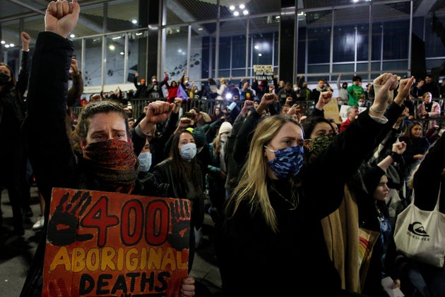 Protestors chant and bend down on their knees in Martin Place during a 'Black Lives Matter' rally on June 02, 2020 in Sydney, Australia.