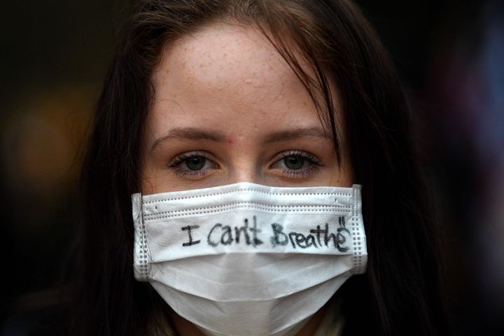 A protester wears a face mask during a rally for justice in Sydney on June 2, 2020, against the deaths of members of the Aboriginal community in Australia and the death of George Floyd.