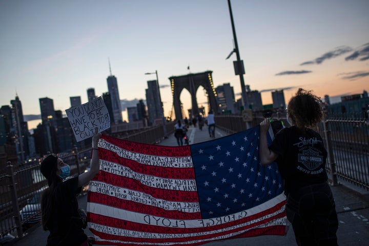 Protesters march across the Brooklyn Bridge as part of a solidarity rally calling for justice over the death of George Floyd on June 1, 2020, in the Brooklyn borough of New York.