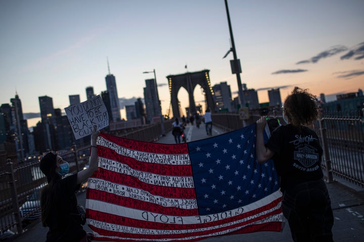 Protesters march across the Brooklyn Bridge as part of a solidarity rally calling for justice over the death of George Floyd on June 1, 2020, in the Brooklyn borough of New York. 