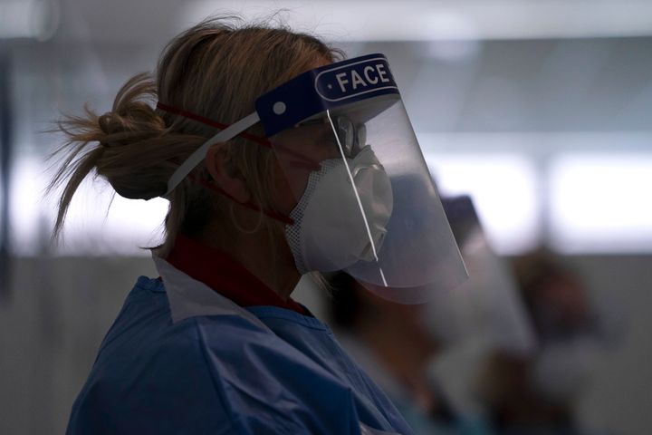 A medic, pictured in April, wears PPE at the Nightingale Hospital in Manchester