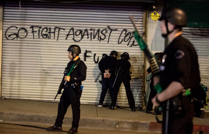 Police officers arrest a protester in Lost Angeles on Sunday during a demonstration over the death of George Floyd, who died last week in Minneapolis after a white police officer knelt on his neck. 