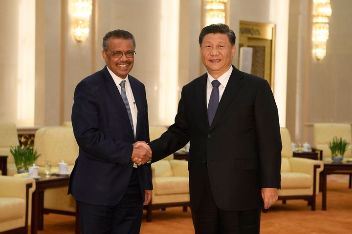 In this Jan. 28, 2020, file photo, Tedros Adhanom Ghebreyesus, director general of the World Health Organization, left, shakes hands with Chinese President Xi Jinping before a meeting at the Great Hall of the People in Beijing. Throughout January, the World Health Organization publicly praised China for what it called a speedy response to the new coronavirus. It repeatedly thanked the Chinese government for sharing the genetic map of the virus “immediately” and said its work and commitment to transparency were “very impressive, and beyond words.” But behind the scenes, there were significant delays by China and considerable frustration among WHO officials over the lack of outbreak data, The Associated Press has found. (Naohiko Hatta/Pool Photo via AP, File)