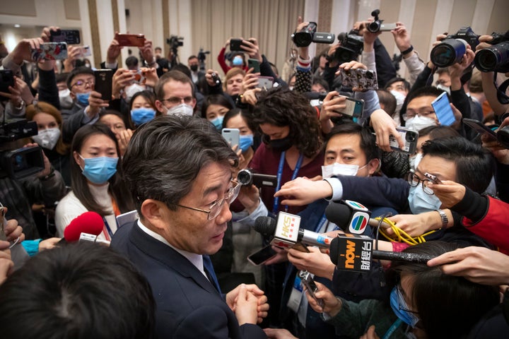 Gao Fu, bottom, the head of the Chinese Center for Disease Control and Prevention (CDC), speaks to journalists after a press conference about a virus outbreak at the State Council Information Office in Beijing, Sunday, Jan. 26, 2020. (AP Photo/Mark Schiefelbein)