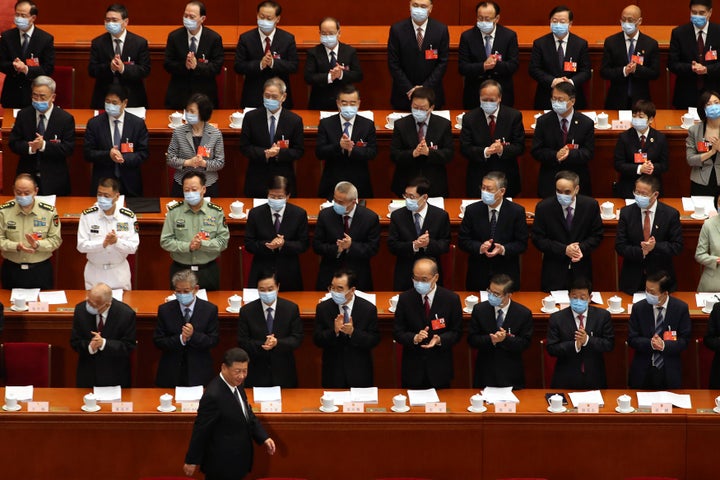 Delegates applaud as Chinese President Xi Jinping arrives for the opening session of China's National People's Congress (NPC) at the Great Hall of the People in Beijing, Friday, May 22, 2020. (AP Photo/Ng Han Guan, Pool)