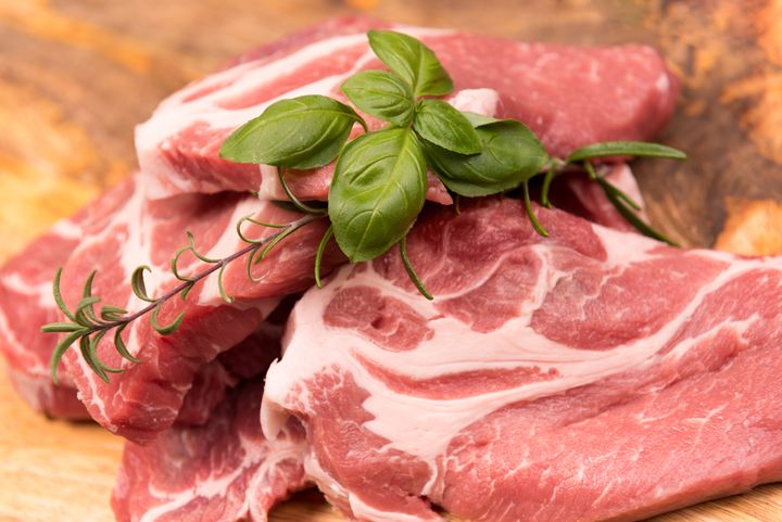 raw pork meat on a wooden background