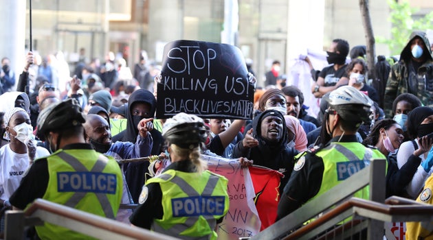 Activists and protesters rally in front of Toronto police headquarters on May 30, 2020 after the...