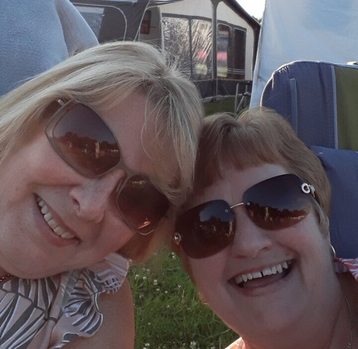 Fiona and a friend raising a glass on holiday