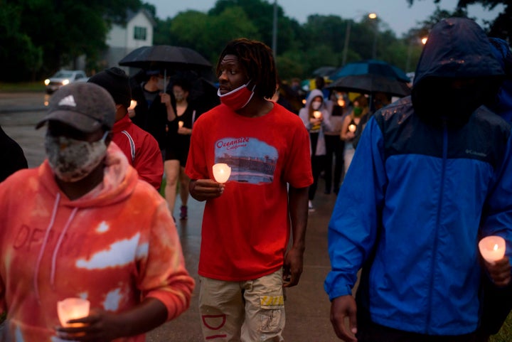 People in Houston march as they mourn the death of George Floyd during a candlelight vigil at Resurrection Metropolitan Community Church on May 31.