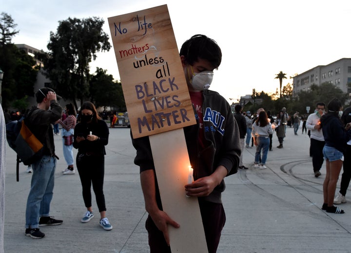 Alec Rosenatck waits for a protest and candlelight vigil in front of Pasadena City Hall on May 31 in California.