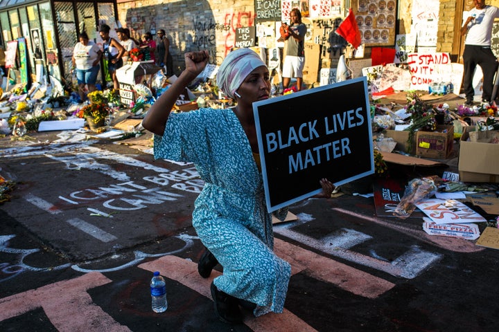 A Somali American protester kneels during a call for justice for George Floyd outside the Cup Foods store, where Floyd was killed, in Minneapolis on June 1.