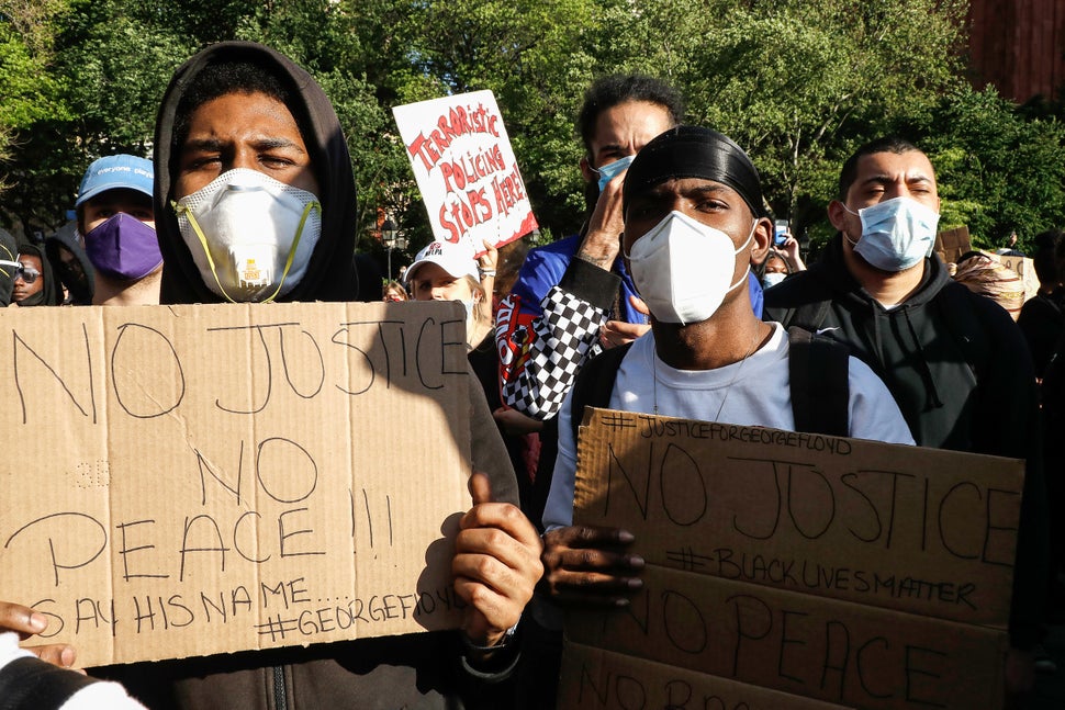 Protesters hold placards in New York's Washington Square Park during a demonstration in response to the killing of George Flo