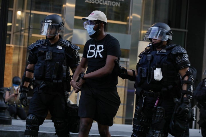 A protestor is being arrested by Washington D.C. Metropolitan Police officers during a protest over the death of George Floyd, an unarmed black man who died after being pinned down by a white police officer last week.