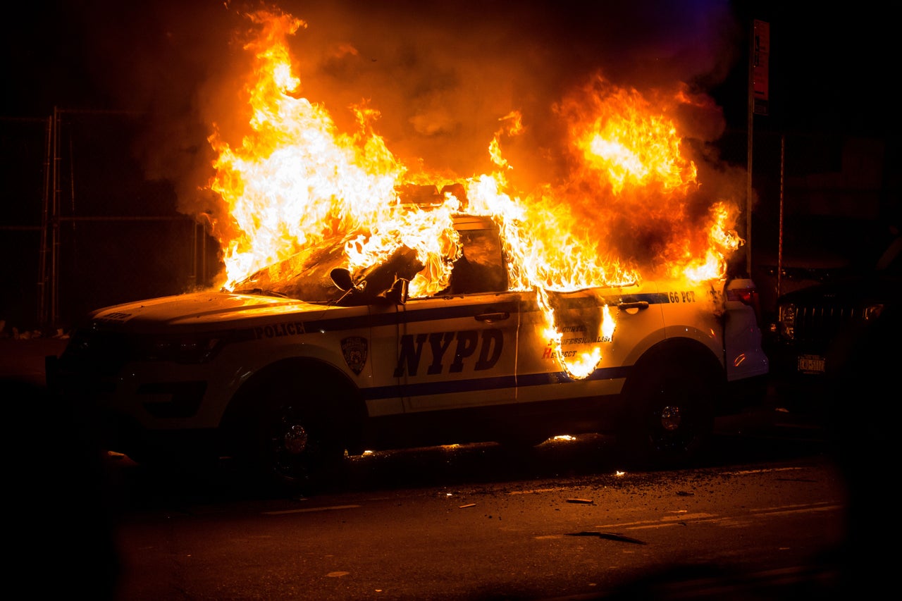 A New York Police Department SUV is burned Sunday during a Brooklyn protest over the police killing of George Floyd in Minneapolis.