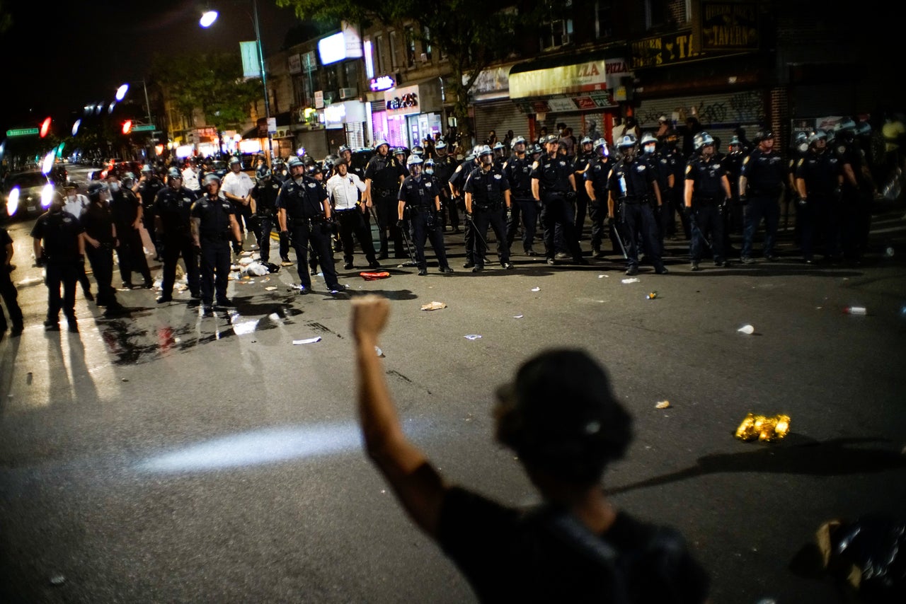 NYPD officers keep an eye on protesters in Brooklyn on Saturday while they clash during a march against the death in Minneapolis police custody of George Floyd.