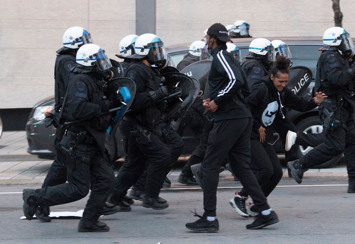 Police push back protesters during a demonstration on May 31, 2020 calling for justice in the death of George Floyd and victims of police brutality in Montreal.